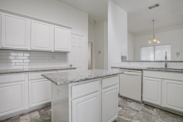 kitchen with white dishwasher, white cabinetry, and a chandelier