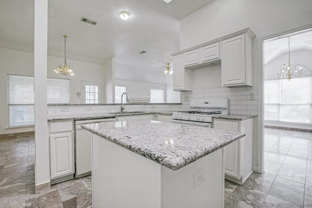 kitchen featuring kitchen peninsula, white cabinetry, sink, and white appliances