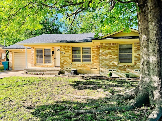 1709 W Birge St, Sherman, TX 75092 - view of front facade with brick siding, concrete driveway, a garage, and a shingled roof