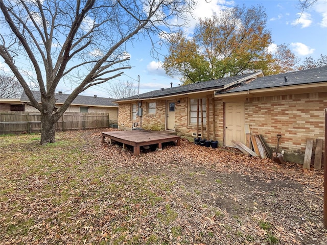 rear view of property featuring a deck