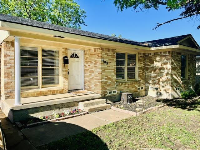 1709 W Birge St, Sherman, TX 75092 - property entrance featuring brick siding and crawl space