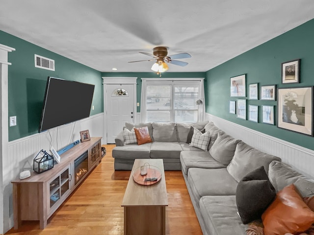 living room featuring ceiling fan and light wood-type flooring