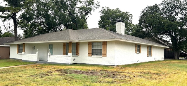 single story home with a front lawn and a porch