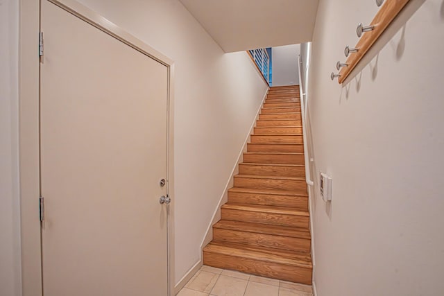 staircase featuring tile patterned floors