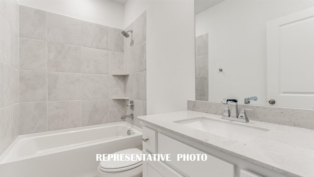 full bathroom featuring toilet, vanity, and tiled shower / bath