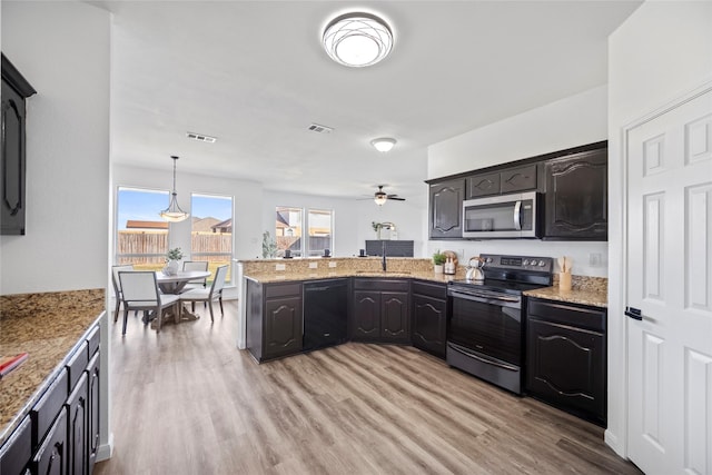 kitchen with ceiling fan, sink, stainless steel appliances, pendant lighting, and light wood-type flooring