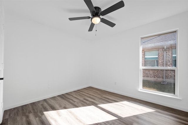 empty room with hardwood / wood-style floors and ceiling fan