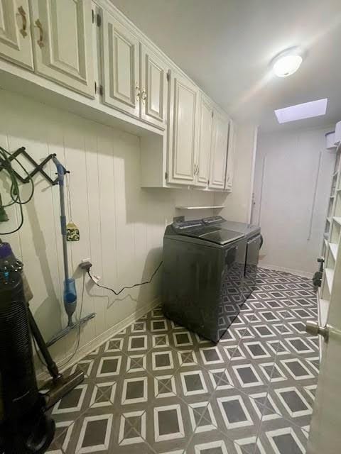 laundry area with washing machine and dryer and cabinets