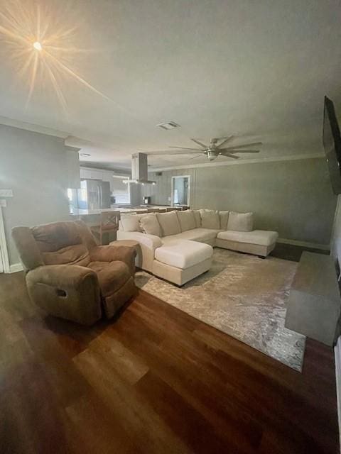 living room featuring wood-type flooring and ornamental molding