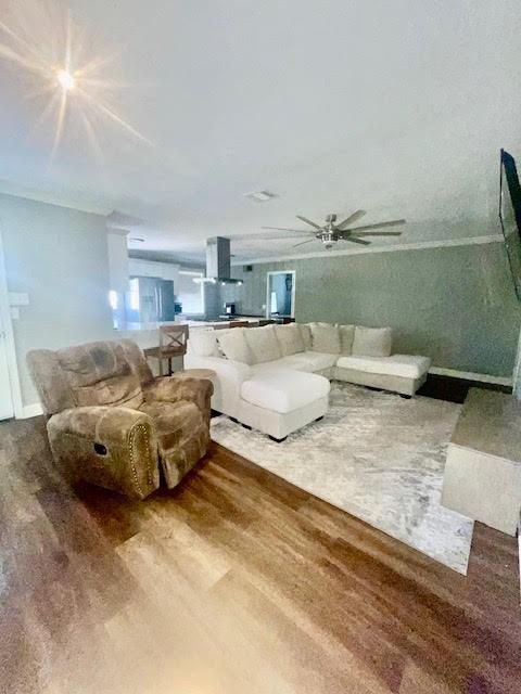 living room featuring hardwood / wood-style flooring and ceiling fan