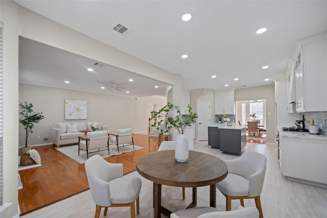 dining room featuring light hardwood / wood-style floors and ceiling fan