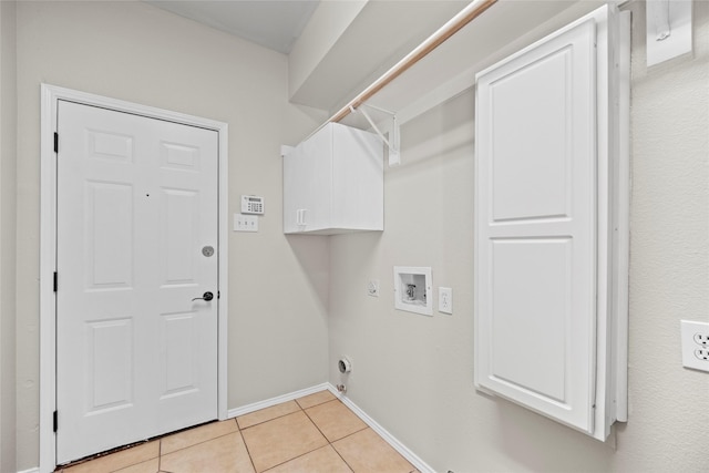 washroom with cabinets, light tile patterned floors, and washer hookup