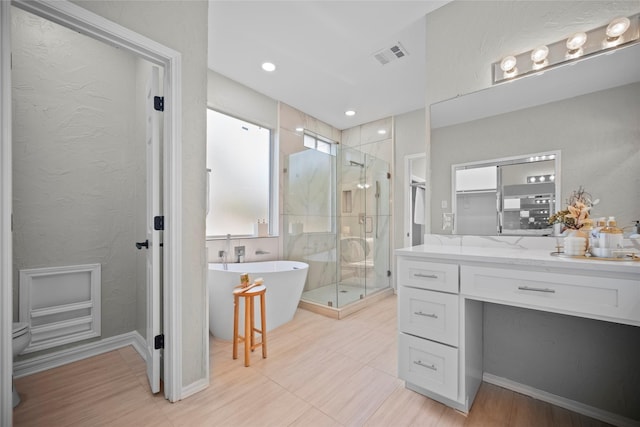 bathroom with separate shower and tub and vanity