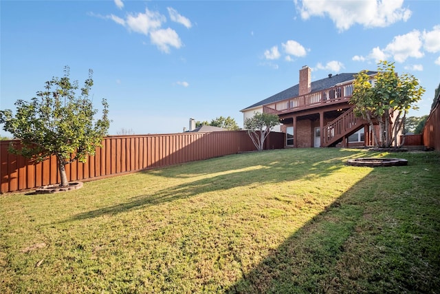 view of yard with a wooden deck and an outdoor fire pit