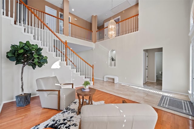 living room with hardwood / wood-style floors and a high ceiling