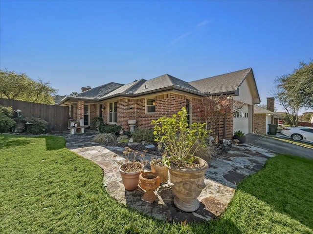 view of front of house featuring a garage and a front lawn