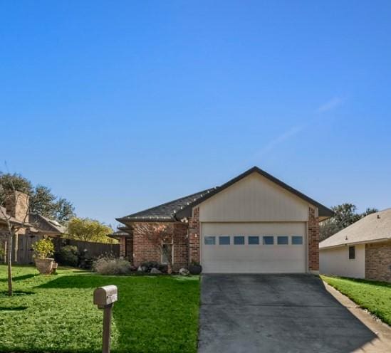 ranch-style home with a front lawn and a garage