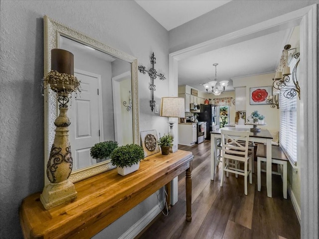 dining room featuring dark hardwood / wood-style flooring and an inviting chandelier