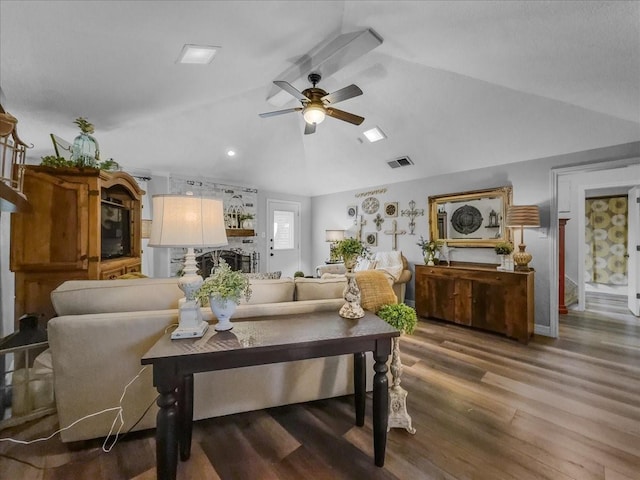 living room featuring hardwood / wood-style floors, ceiling fan, and lofted ceiling