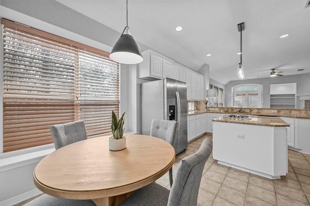 dining space featuring light tile patterned floors and ceiling fan