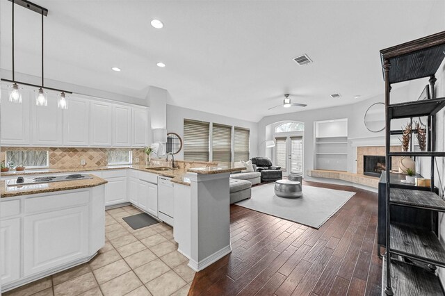 kitchen featuring pendant lighting, white dishwasher, ceiling fan, white cabinetry, and stainless steel gas cooktop