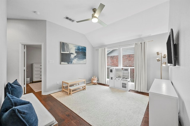 living room featuring ceiling fan, dark wood-type flooring, and vaulted ceiling