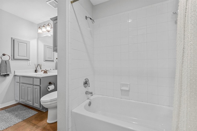 full bathroom featuring toilet, hardwood / wood-style floors, vanity, and shower / tub combo with curtain