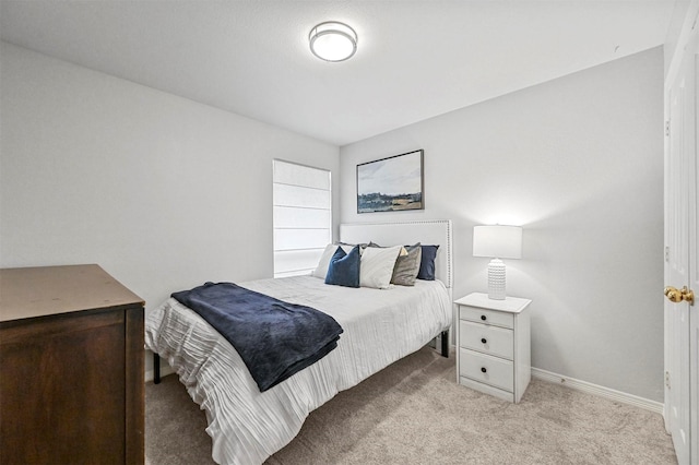 bedroom featuring light carpet