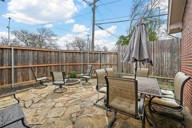 view of patio with a fire pit