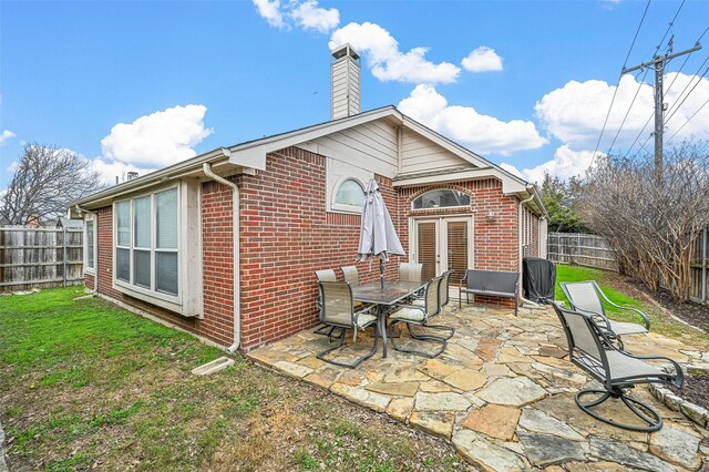 back of property featuring a patio and a lawn