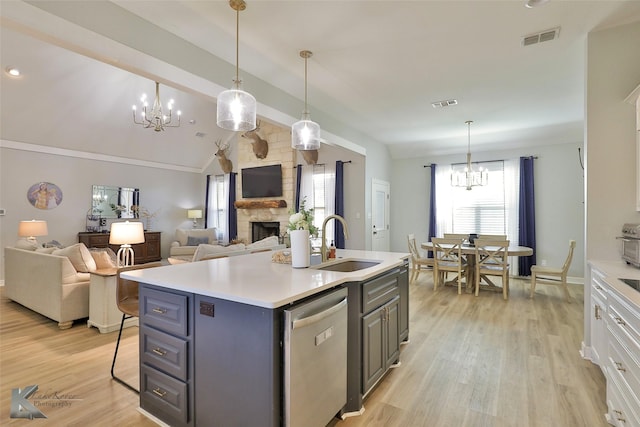 kitchen featuring sink, a chandelier, a center island with sink, dishwasher, and white cabinets