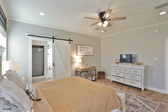 bedroom with ornamental molding, a barn door, ceiling fan, and light wood-type flooring