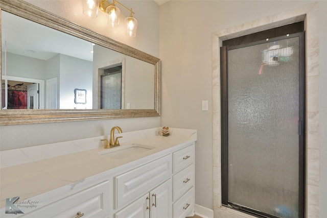 bathroom featuring vanity and a shower with shower door