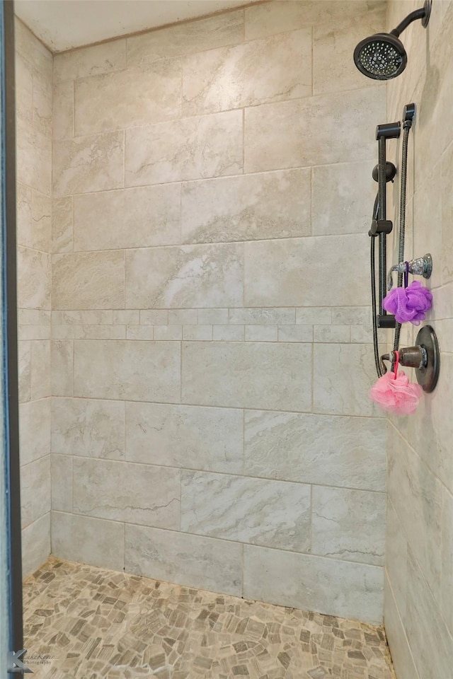 bathroom with tiled shower