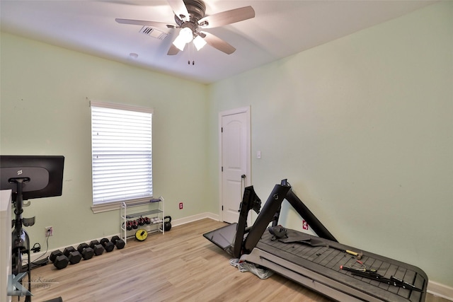 exercise room featuring ceiling fan and light hardwood / wood-style floors