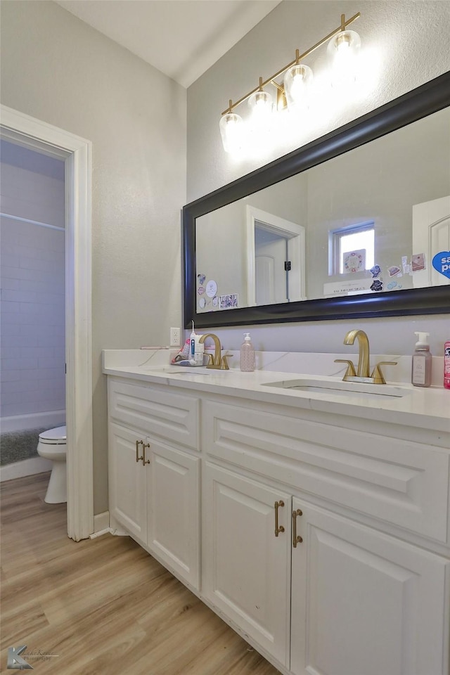 bathroom featuring vanity, toilet, and hardwood / wood-style floors