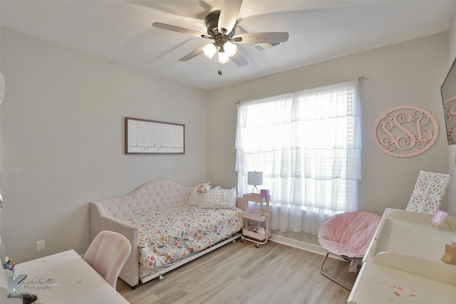 bedroom with ceiling fan and light wood-type flooring