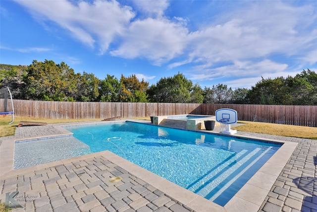 view of swimming pool featuring an in ground hot tub and a patio