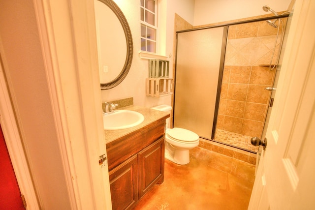 bathroom with vanity, toilet, and a shower with door