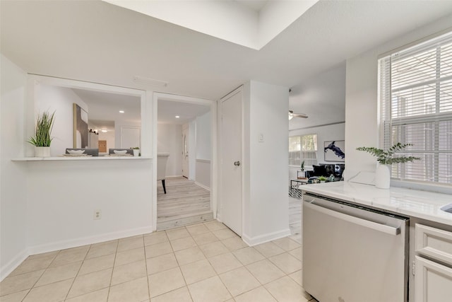 kitchen with light tile patterned floors, stainless steel dishwasher, and ceiling fan