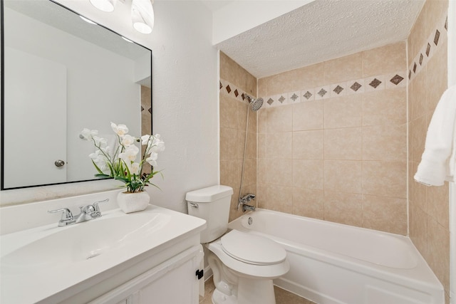 full bathroom featuring vanity, a textured ceiling, toilet, and tiled shower / bath