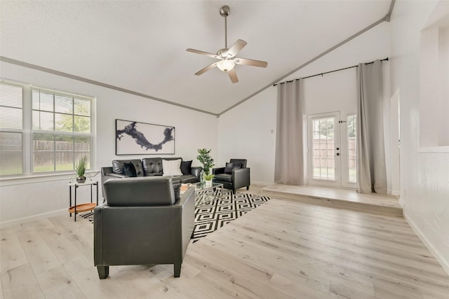 interior space with crown molding, ceiling fan, high vaulted ceiling, and light wood-type flooring