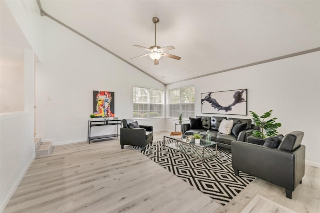 living room featuring ceiling fan, light wood-type flooring, crown molding, and high vaulted ceiling