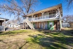 back of property featuring a yard