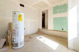 unfurnished room with water heater