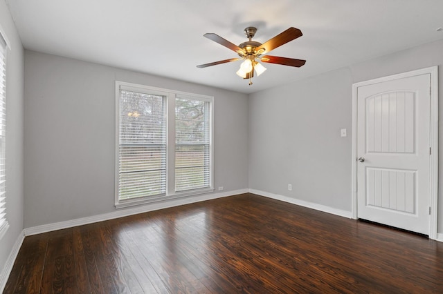 unfurnished room with dark hardwood / wood-style flooring and ceiling fan