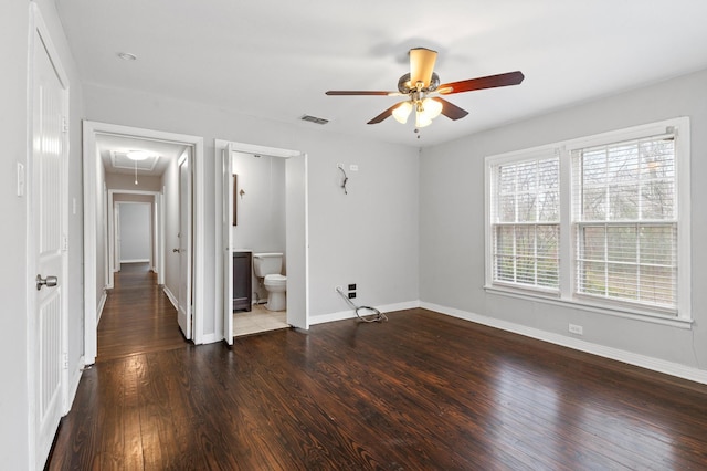 spare room with dark wood-type flooring and ceiling fan