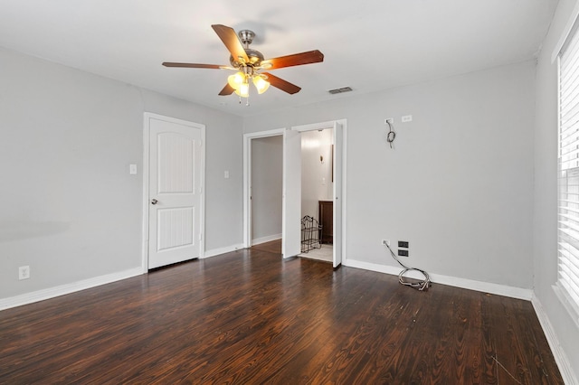 empty room featuring ceiling fan and dark hardwood / wood-style floors