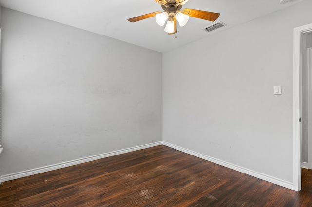 empty room featuring dark hardwood / wood-style flooring and ceiling fan