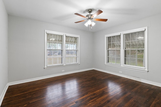 empty room featuring dark hardwood / wood-style floors and ceiling fan